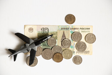 Russian rubles on a white background and a children's plane. Financial sanctions against Russia....
