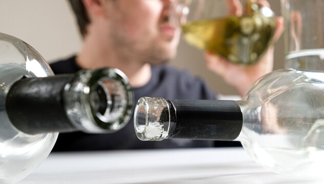 A man with alcohol dependence drinks brine from a jar of aole cucumbers, a man in a hangover, a long banner