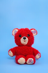 vintage children's toy - red teddy bear on a blue background