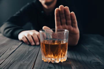 Deurstickers Man with a gesture refuses alcohol © Daniel