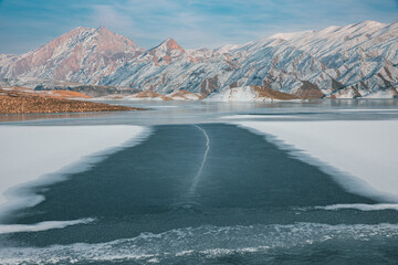 frozen lake with mountain