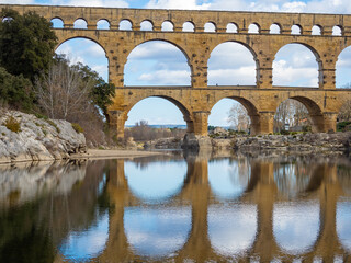 Fototapeta premium The magnificent Pont du Gard, an ancient Roman aqueduct bridge, Vers-Pont-du-Gard in southern France. Built in the first century AD to carry water to the Roman colony of Nemausus (Nîmes)