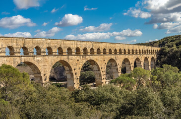 Fototapeta premium The magnificent Pont du Gard, an ancient Roman aqueduct bridge, Vers-Pont-du-Gard in southern France. Built in the first century AD to carry water to the Roman colony of Nemausus (Nîmes)