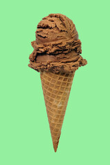 double scoops chocolate ice cream cone on green background