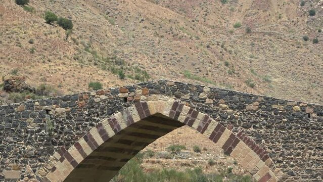 Medieval bridge of Adrano, Sicily, of arabic origin and saracen. Called Simeto river  lava gorges. Video 4k