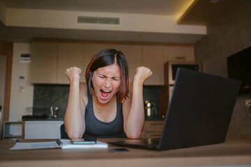 remote job, failure and stress concept - angry young woman with laptop computer working at home...