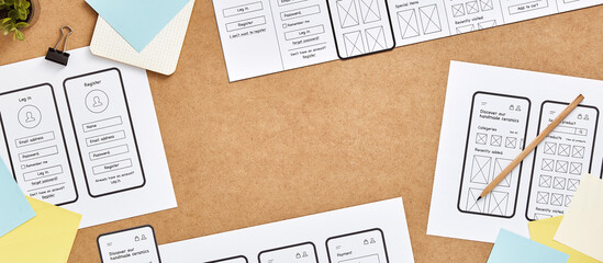 Mobile responsive website project concept web banner. Top view image of web UX designer workspace with mobile app wireframe sketches and copy space. 
