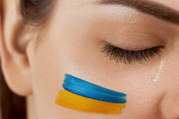 Ukraine crisis concept. Eye, crying with a tear running down her cheek