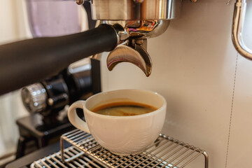 Extract coffee from the coffee machine in the coffee shop