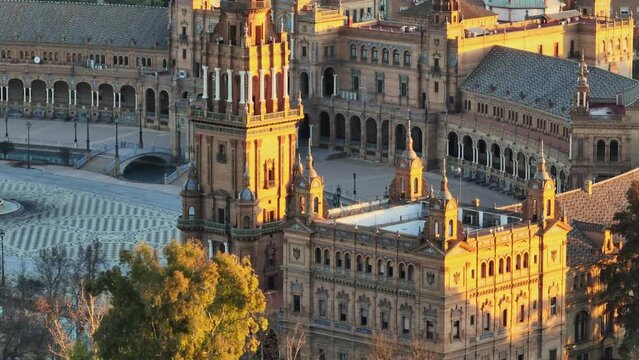 Aerial tele shot of Plaza de Espana complex in morning sun lights. Flying around Plaza de Espana - Spanish Square - in Sevilla, Spain