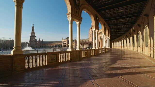Camera moves along the corridor with columns in Plaza de Espana - Spanish Square -, Sevilla, Spain. Walking through Plaza de Espana complex. Gimbal high quality shot, 4K