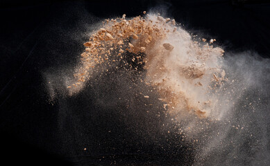 Soil explosion isolated on black background