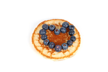 Pancakes with red fruits: blueberries, raspberries and blackberries on a white background 