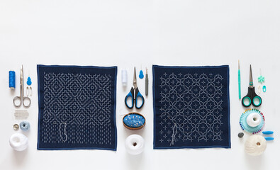 Process of hand embroidery with white threads on blue fabric in traditional Japanese Sashiko style....