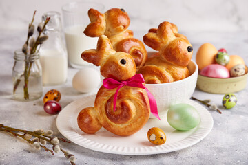Buns made from yeast dough in a shape of Easter bunny, and colored eggs. Traditional Easter symbols...