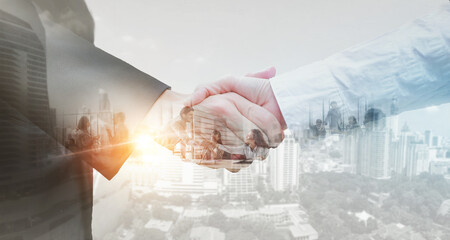 Business partner shaking hands in city with double exposure of interface data. Teamwork concept.