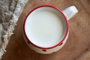 Fresh milk kefir in a white and red cup