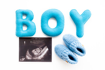Ultrasound scan of unborn baby with letters boy