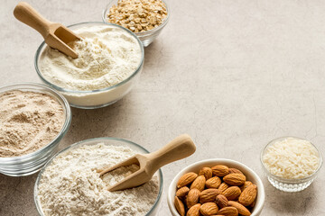 Various types of gluten free flour - almond peanut oat rice flour in bowls