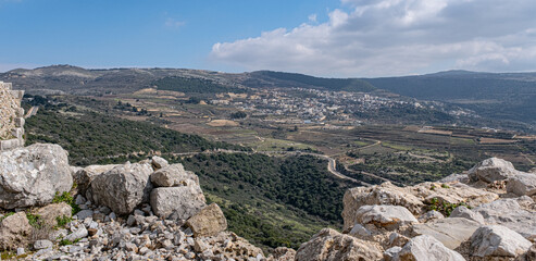 Fototapeta na wymiar View of Ein-Qiniyye, a Druze village located on the southern foothills of Mount Hermon as seen from Nimrod Crusader Castle southern wall, Golan Heights, Israel. 