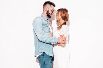 Sexy smiling beautiful woman and her handsome boyfriend. Happy cheerful family having tender moments near white wall in studio.Pure cheerful models hugging.Embracing each other. Cheerful and happy