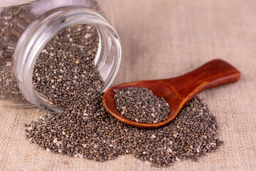 Chia seeds spilled out of the jar. Close-up.