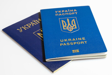 Ukrainian passport on background of Ukrainian flag. Isolated on a white background