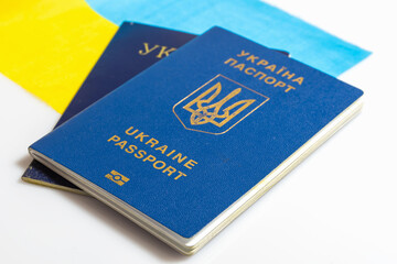 Ukrainian passport on background of Ukrainian flag. Isolated on a white background