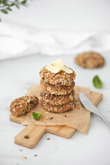 stack of homemade oatmeal cookies with butter and seeds