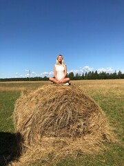 Naklejka na ściany i meble person sitting on a haystack