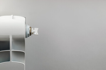 Heating Radiator, White radiator on a white background. Copy space. The concept of rising prices for heat energy.