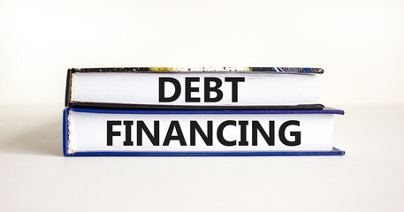Debt financing symbol. Concept words Debt financing on books on a beautiful white table white background. Business finance and debt financing concept, copy space.