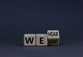 We want and hear you symbol. Turned the wooden cube and changed concept words we want to we hear. Beautiful grey background, copy space. Business support we want and hear you concept.