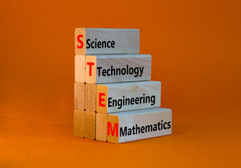 STEM science technology engineering mathematics symbol. Words STEM science technology engineering mathematics on orange background. Business STEM science technology engineering mathematics concept.