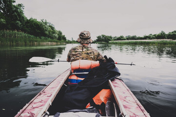 A man floats on a summer river in a kayak in the Rostov region.