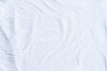 Background with a slightly crumpled fabric in white. Fine texture of cotton fabric.