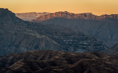 Аul - the ghost of Kurib in the mountains of Dagestan against the backdrop of sunset.