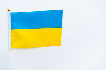 Top view of ukrainian flag on white background with copy space.