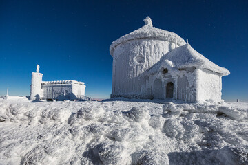 St. Lawrence Chapel on the top of Śnieżka in the Karkonosze Mountains. Winter view of the snow-covered building.