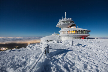Winter view of the Meteorological Observatory on Śnieżka in the Karkonosze Mountains. The night landscape looks like it's on another planet.