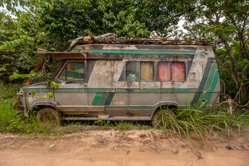 Abandon old worn out rusted van left on the side of a dirt road in a remote area of Brazil