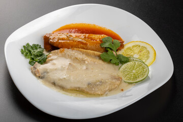 herring fillets on a plate with two kinds of sauce with lemon and lime