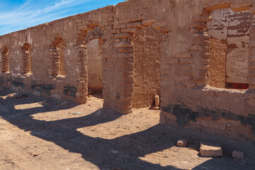 Ruins of abandoned houses in a mining ghost town from the nitrate era in the Atacama desert in the...