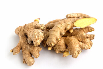 Roots of a fresh ginger plant on a white isolated background close-up.