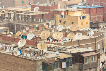 CAIRO, EGYPT - January 2022: Landscape photograph of Old Cairo's many rooftops with satellite...