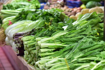 Choy sum or Chinese flowering cabbage sold on stall at the marketplace in china. A leafy vegetable commonly used in Chinese cuisine. Foods rich in vitamins and plant fiber. 