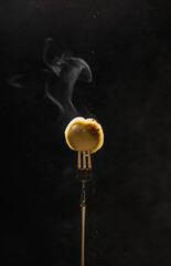 russian dumplings on a fork with steam