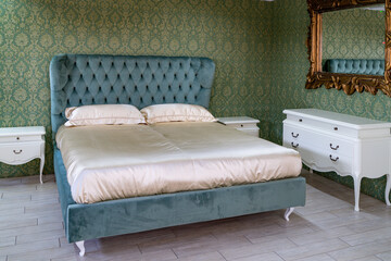 The interior is a beautiful green bed with a white blanket