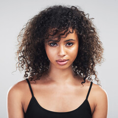 Youre worthy just as you are. Studio shot of a beautiful young woman posing against a grey...