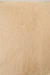 Old crumpled beige paper background.